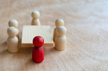 Red wooden figure leading the meeting or discussion. Meeting or discussion concept