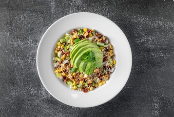 Healthy and vibrant bowl of Mexican-style corn salad with avocado