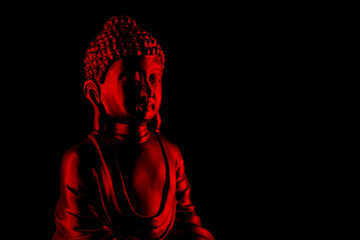 Buddha Purnima and Vesak day concept, Red Buddha statue with low key light against deep black background close up. Meditation - obrazy, fototapety, plakaty