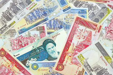 Big pile of Iranian Rial IRR banknotes from Iran as the background on flat surface close up