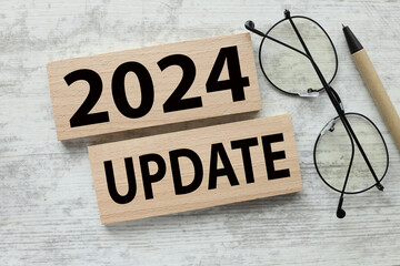text 2024 UPDATE two wooden blocks on a wooden background