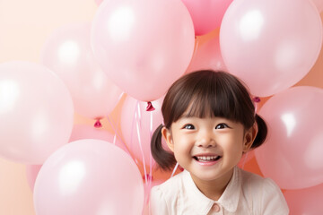 Fototapeta na wymiar Happy asian little girl excited looking up in the balloons