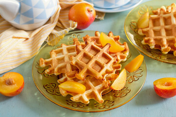 Sweet fluffy classic waffles served with plums - 676831337