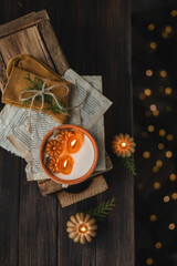 Autumn still life with a candle and pumpkins, warm socks