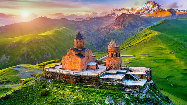 Aerial view of Gergeti trinity church at sunrise in Georgia. - Powered by Adobe