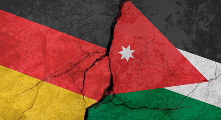 Germany and Jordan flags, concrete wall texture with cracks, grunge background, military conflict concept