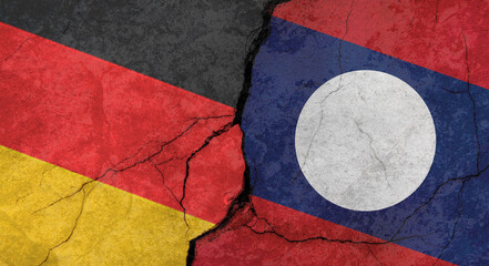 Germany and Laos flags, concrete wall texture with cracks, orange background, military conflict concept