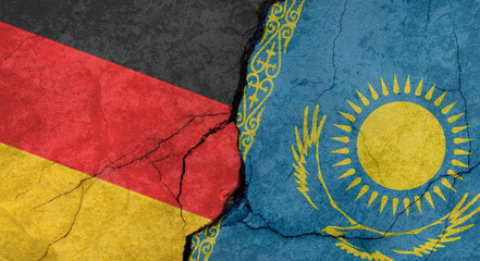 Germany and Kazakhstan flags, concrete wall texture with cracks, grunge background, military conflict concept