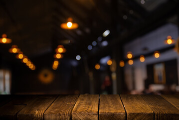 image of wooden table in front of abstract blurred background of resturant lights . High quality photo