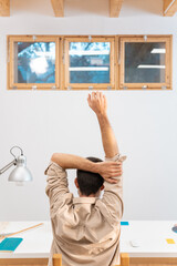 Fototapeta na wymiar Young man stretching his spine at home. High quality photo