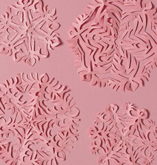 Hand cut diy pink paper snowflakes.