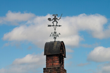 weather vane against a blue sky