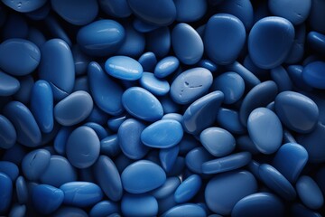 Blue pebbles texture as background, top view. Closeup