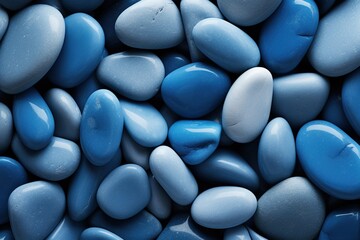 Fototapeta premium Blue pebbles texture as background, top view. Closeup