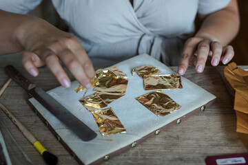 A renovation worker with pieces of gold
