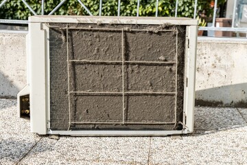 Closeup of an old dirty air conditioner on the street
