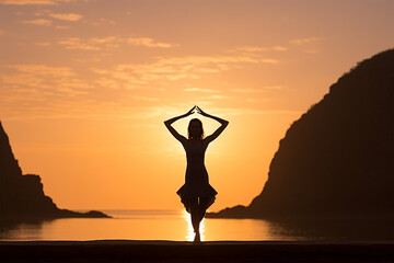 silhouette of woman practicing yoga on a calm beach at sunrise