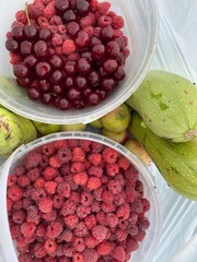 photograph of the harvest of cherries and raspberries and zucchini vegetables close-up top view High quality photo