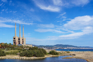 Sant Adriá, Central Thermal Station of Fecsa in Badalona, Barcelona, Spain. Abandoned boiler room with three chimneys surrounded by nature and Besos river.