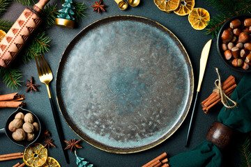 Christmas composition of table setting: plate, cutlery and Christmas decoration. Top view. On a...