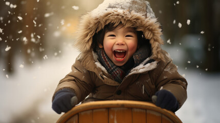 Fototapeta premium A joyful child with a beaming smile, wearing winter clothing and holding onto a wooden sled, surrounded by sparkling snowflakes in the glowing light of the winter sun.