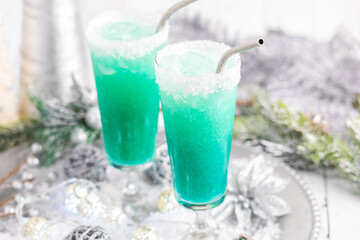 Cold and refreshing Jack Frost cocktails with coconut around the rim.