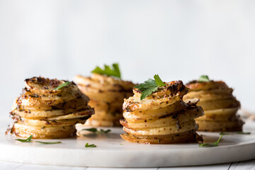 A straight on view of seasoned potato stacks garnished with parsley.