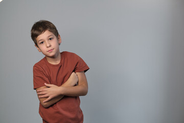 A stern-faced child with arms folded signifies resilience. Echoes the need for understanding youth...