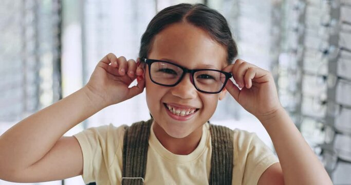 Kid, happy girl and shopping for glasses for eye care, vision or health in optometrist store. Youth, excited and silly emoji on face with smile for spectacles for choice of lens, frame or eyewear