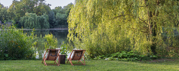 Relaxing wooden chairs Am Waldsee in Lehrte Lower Saxony in Germany © Hilda Weges