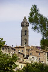 Fototapeta na wymiar Vertical shot of the ancient bell tower in the historic center of Peccioli, Italy