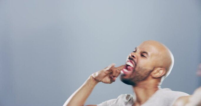 Man, face and rock hand or energy head bang for dance music, heavy metal on grey background. Male person, emoji gesture and crazy wild anarchy for concert fun symbol, punk attitude or mockup