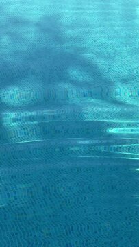 Swimming pool water as summer holiday background, crystal blue texture, summertime and travel inspiration, vertical reel, story slow motion