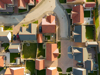 Drone top down view of new houses in the UK. Showing mainly detached houses down quite Cul De Sacs. Artificial lawns can be seen in the gardens.