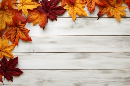 Fall and Autumn leaves on a whitewashed wood plank board. 
