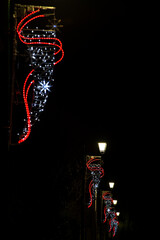 Christmas lights garland decoration on sreetlights at the street, France.
