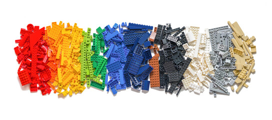 Naklejka premium Lot of colorful rainbow toy bricks background on white. Educational toy for children. Novosibirsk, Russia - October 26, 2023.