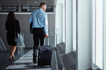Hall, walking or back of business people in airport with suitcase, luggage or baggage on company...
