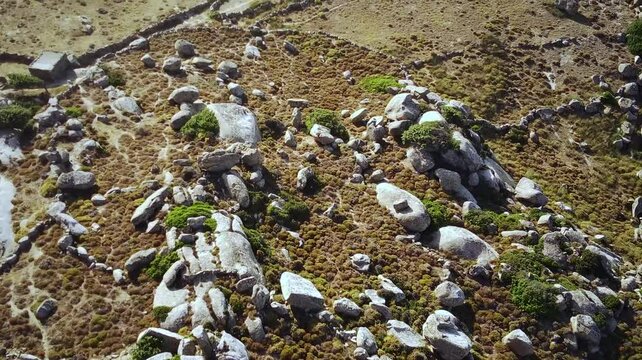 Drone footage of granite boulders and abandoned stone houses in Volax village, Tinos Island, Greece