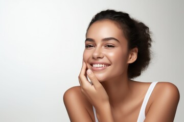 Beautiful smiling young woman with soft glow skin and bare shoulders.