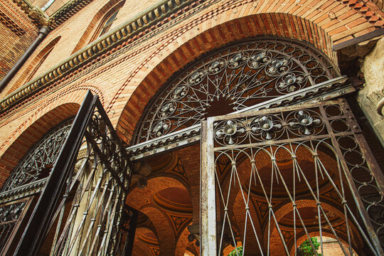 Chernivtsi National University. Metal gate of seminary wing of ex Residence of Bukovinian and Dalmatian Metropolitans. Byzantine and Moorish architecture. Postcard style. Outdoor shot