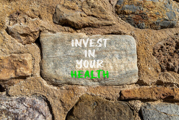 Invest in your health symbol. Concept word Invest in your health on beautiful stone. Beautiful stone wall background. Invest in your health concept. Copy space.