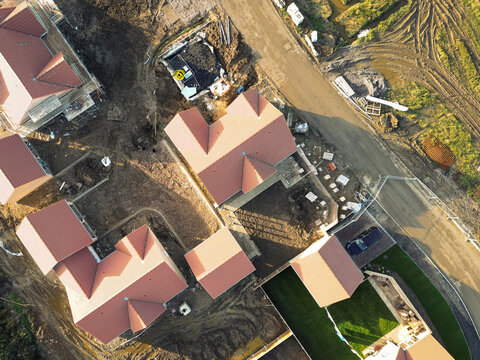 Drone top down view of private and affordable housing in development in East Anglia, UK. Some bungalows are seen sold and lived in.