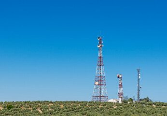 Communications towers, red and white antenna