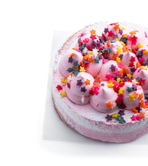 Pink Sponge cake decorated with small meringue on top isolated on white