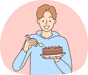 Smiling man eat cake with spoon