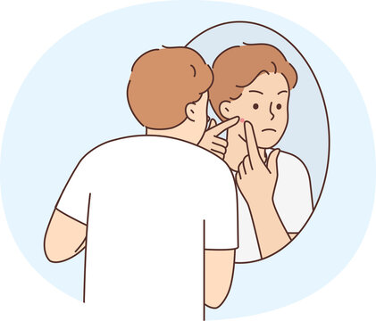 Young man stressed with pimple on face