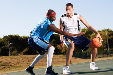 Men, player and basketball game or defense in court challenge team, dunk on rival. Male people, running dribble and score point in summer park in fitness clothes for competition, athlete for winning