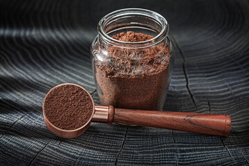 Coffee Ground in Glass Jar And Spoon With Wooden Handle