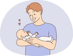 Happy father holding baby in arms